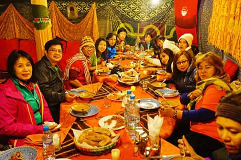 Travellers sharing a traditional Moroccan dinner